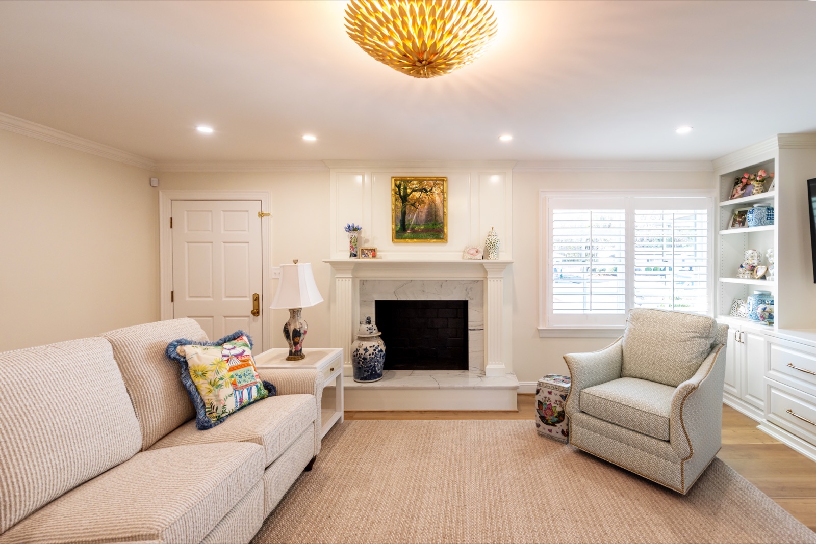 Living room fireplace surround in Calacatta Gold finish with ogee edge